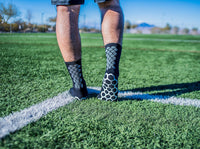 Black Genio grip socks.